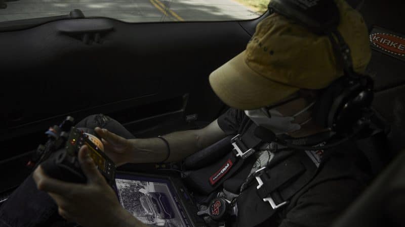 Camera Assistant pulling focus in the fifth /rear seat of Mantis camera car